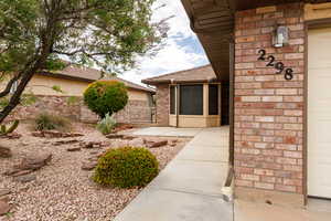 Property entrance with brick siding and fence