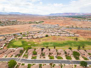 Aerial view of property's location featuring nearby suburban area and mountains