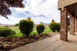 View of patio featuring a mountain view and golf course
