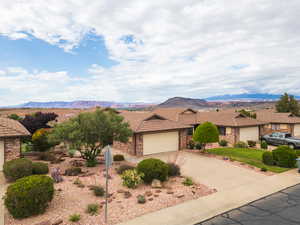 Single story home with a tile roof, concrete driveway, and an attached garage