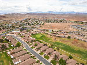 Aerial overview of property's location with nearby suburban area and a mountain backdrop