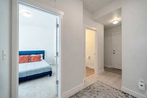 Hallway featuring wood finished floors and baseboards