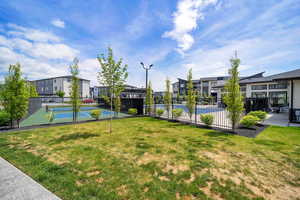 View of property's community featuring a residential view and a tennis court