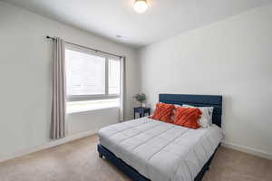 Bedroom featuring carpet flooring and baseboards