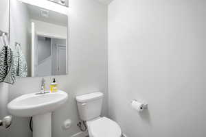 Bathroom featuring toilet and baseboards