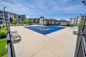 View of pool featuring a residential view and fence