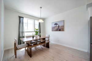 Dining space with baseboards and light wood-type flooring
