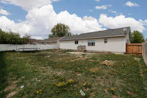Rear view of house with a trampoline