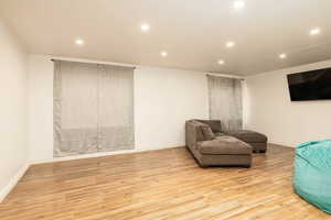 Sitting room featuring recessed lighting, wood finished floors, and baseboards