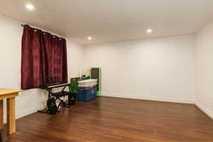 Misc room featuring wood finished floors, baseboards, and recessed lighting