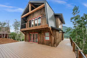 Back of house with a deck with mountain view