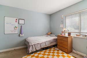 Bedroom featuring light carpet