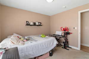 Carpeted bedroom featuring baseboards