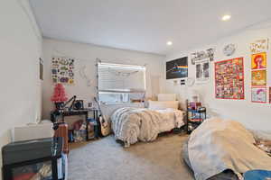 Carpeted bedroom with recessed lighting