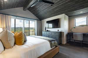 Bedroom with multiple windows, dark wood-style flooring, access to exterior, baseboards, and wood ceiling