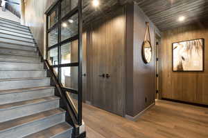 Staircase with wood finished floors and baseboards