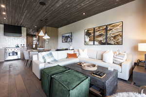Living room with hardwood / wood-style flooring, wooden ceiling, and recessed lighting