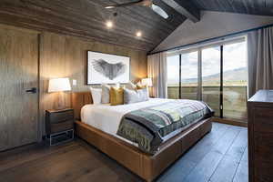 Bedroom featuring access to exterior, wood-type flooring, wood walls, wood ceiling, and a mountain view