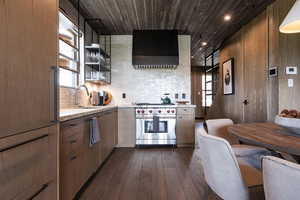 Kitchen with a sink, range hood, premium stove, dark wood-style floors, and wood ceiling