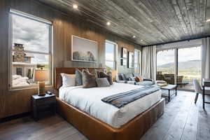 Bedroom featuring access to exterior, multiple windows, light wood-style flooring, wood ceiling, and wood walls