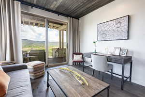 Living room with hardwood / wood-style floors, an office area, and a mountain view