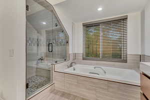 Full bath with tile patterned floors, a garden tub, a stall shower, and recessed lighting