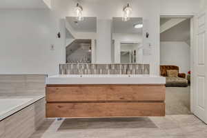Bathroom with double vanity and visible vents