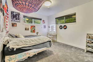 Carpeted bedroom with baseboards