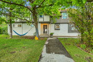 View of front of home with a front lawn and brick siding