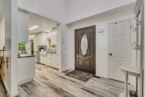 Foyer with baseboards and light wood finished floors