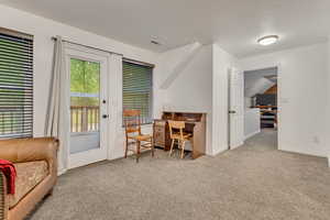Home office with baseboards, visible vents, and carpet floors