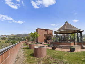 ROOFTOP GARDEN Surrounding community with a gazebo and a mountain view