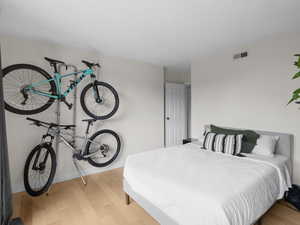 Bedroom featuring wood finished floors and baseboards