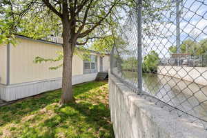 View of property exterior featuring fence