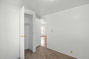 Unfurnished bedroom with carpet floors and a closet
