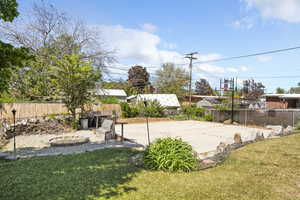 View of yard with basketball court