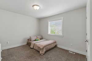 Bedroom featuring carpet flooring and baseboards