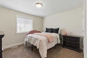 Carpeted bedroom with baseboards