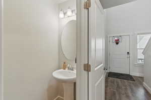 Bathroom with wood finished floors and baseboards