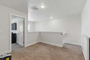 Below grade area with carpet, a textured ceiling, baseboards, and recessed lighting