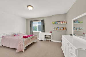 Bedroom with light colored carpet and baseboards