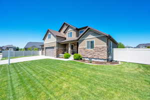 Craftsman-style home with stone siding, an attached garage, concrete driveway, and stucco siding