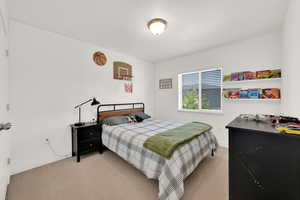 Bedroom with light carpet and baseboards