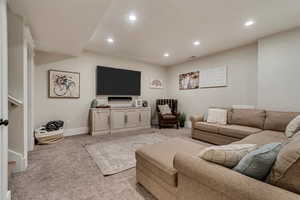 Living area featuring light colored carpet, recessed lighting, and baseboards