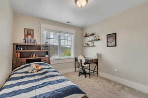 Carpeted bedroom featuring baseboards