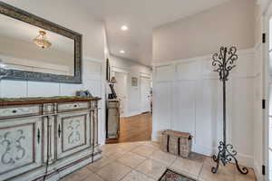 Entrance foyer with a decorative wall and recessed lighting