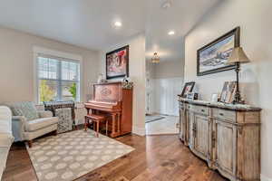 Sitting room featuring recessed lighting, wood finished floors, and baseboards