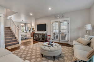 Living area with a chandelier, wood finished floors, plenty of natural light, and recessed lighting
