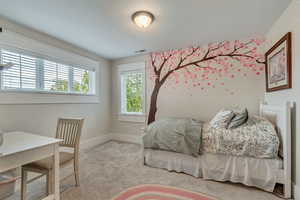 Carpeted bedroom featuring baseboards