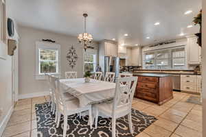Dining space featuring recessed lighting, a chandelier, and baseboards